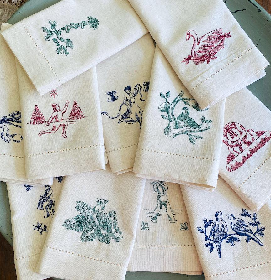https://whitetulipembroidery.com/cdn/shop/products/twelve-days-of-christmas-embroidered-cloth-napkins-set-of-12-napkins-white-tulip-embroidery-2_ca4251c1-01f9-4e48-98f5-419d7a19f2c9.jpg?v=1676306317